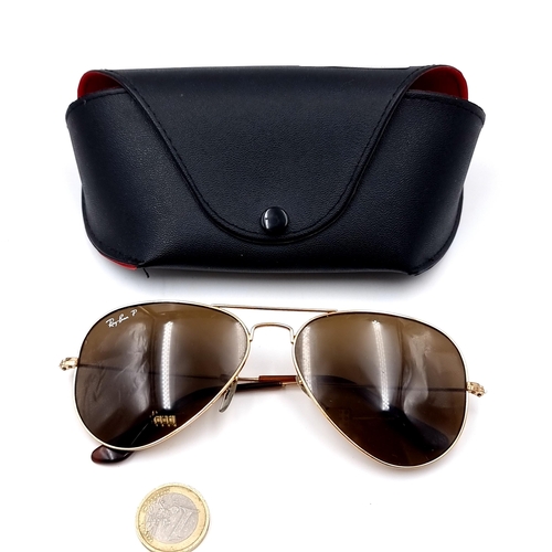 29 - A pair of original gold metal framed marked Ray-Ban aviator style sunglasses. Comes in a pouch.