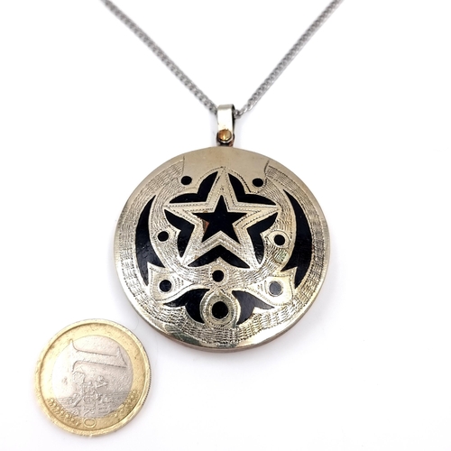 32 - An Asian pendant set with star motif with gold & sterling silver mounts set in onyx stone with silve... 