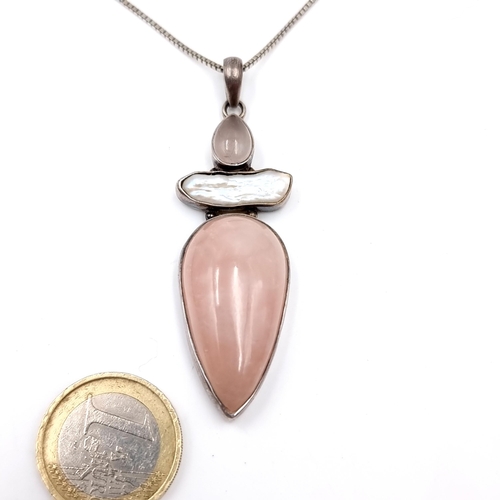 33 - A sterling silver drop pendant necklace set with pink baroque quartz with tear drop setting and silv... 