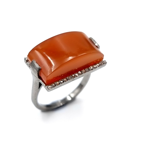 47 - Star Lot : A very unusual carnelian stone ring of 14 carats. Together with a diamond surround of 0.2... 