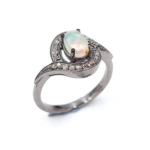 49 - Star Lot : A sterling silver opal stone and diamond ring. Opal - 0.70 carats. Diamond - 0.20 carats.... 