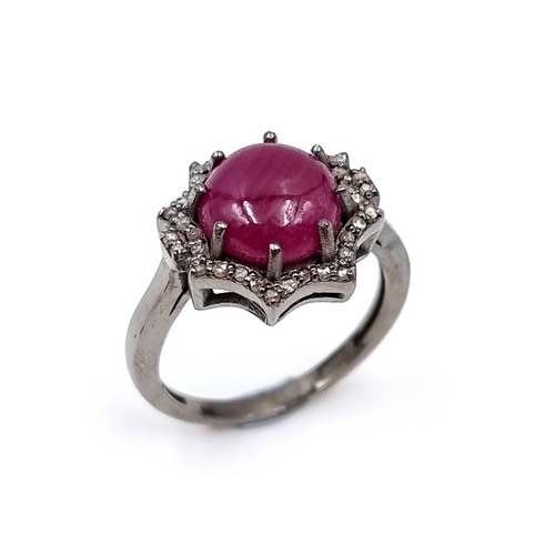 50 - Star Lot : A beautiful cabochon ruby & diamond ring. Ruby - 4.4 carats. Diamond - 0.35 carats. Ring ... 