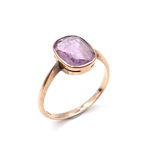 939 - Star Lot : An amethyst stone ring set in nine carat gold. Ring size - Q. Weight - 2.43 grams. Boxed.