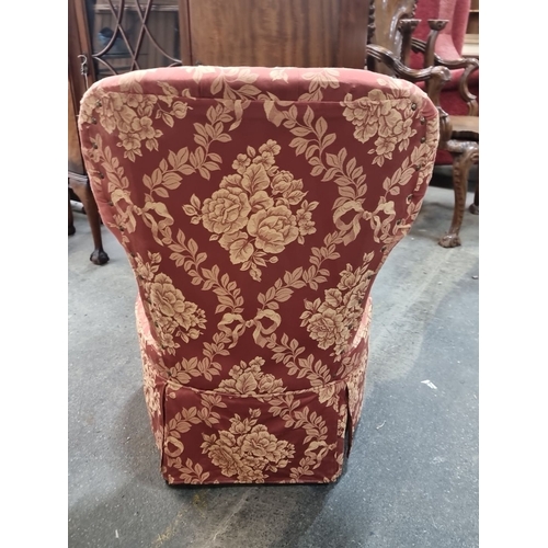 859 - Upholstered mauve floral slipper chair with tufted backrest. The chair features a pleated skirt and ... 