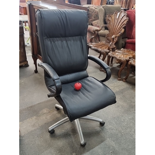 867 - A black leather swivel office chair with adjustable armrests and silver five-pointed base on castor ... 