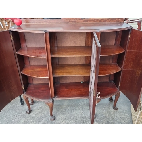 870 - Mahogany display cabinet with bow front design and glazed central door. Features curved legs with cl... 