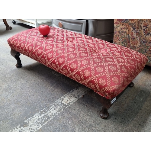 880 - A long Victorian-style upholstered footstool with red and gold tapestry fabric. Features elegant cab... 