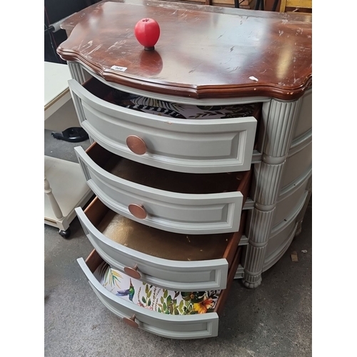 966 - A four drawer chest with curved front, painted in gray with wood top and copper circular handles.