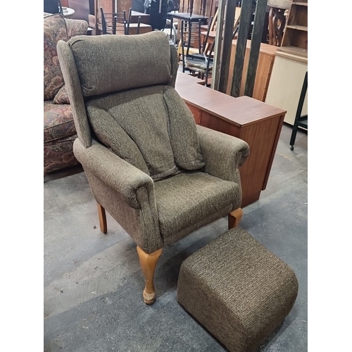 968 - A very comfortable upholstered armchair with wooden legs and matching ottoman