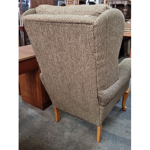 968 - A very comfortable upholstered armchair with wooden legs and matching ottoman