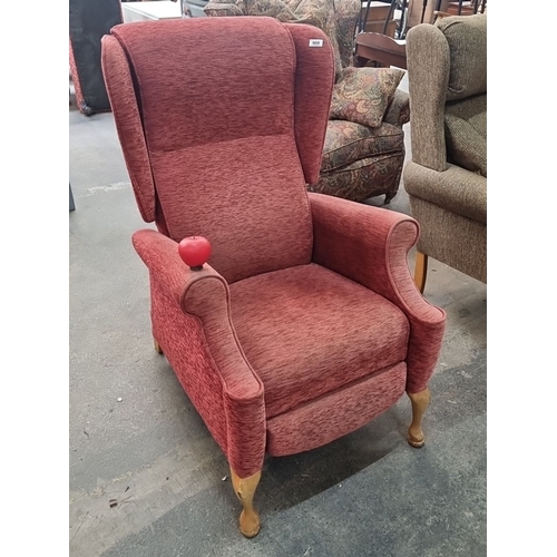 969 - A vintage red fabric wing back recliner armchair with wooden Queen Anne style legs.