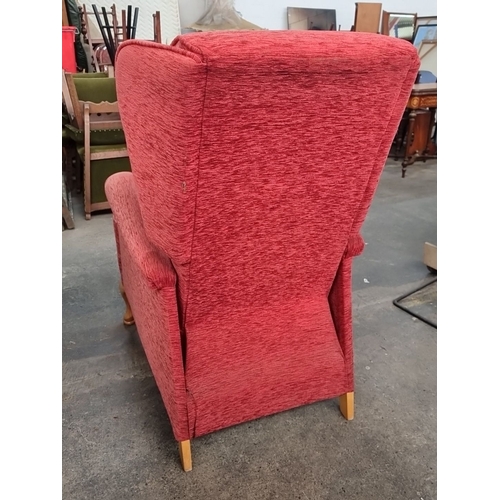 969 - A vintage red fabric wing back recliner armchair with wooden Queen Anne style legs.