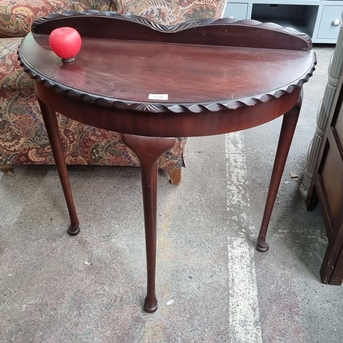 970 - A vintage half-moon table with scalloped edge detail with gallery back and cabriole legs.