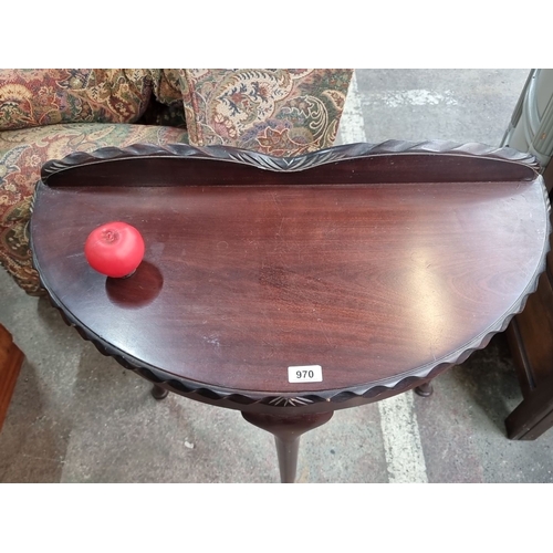 970 - A vintage half-moon table with scalloped edge detail with gallery back and cabriole legs.