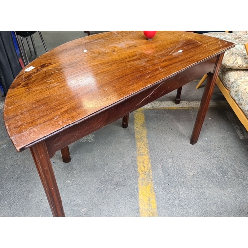 854 - A vintage Mahogany demi-lune table with square tapered legs.