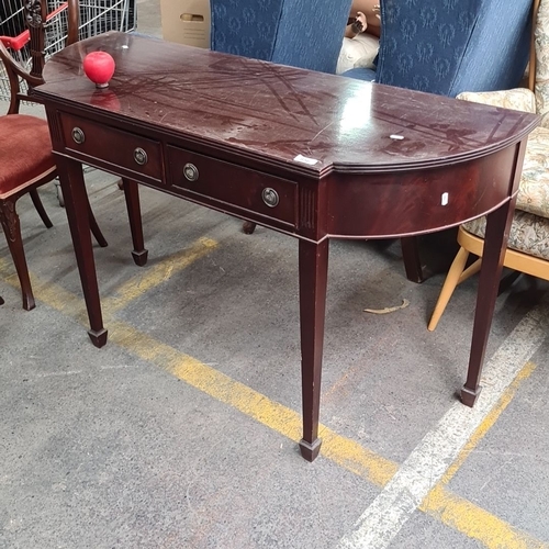 856 - Dark mahogany console table with two drawers, featuring brass ring handles and tapered legs. Appears... 