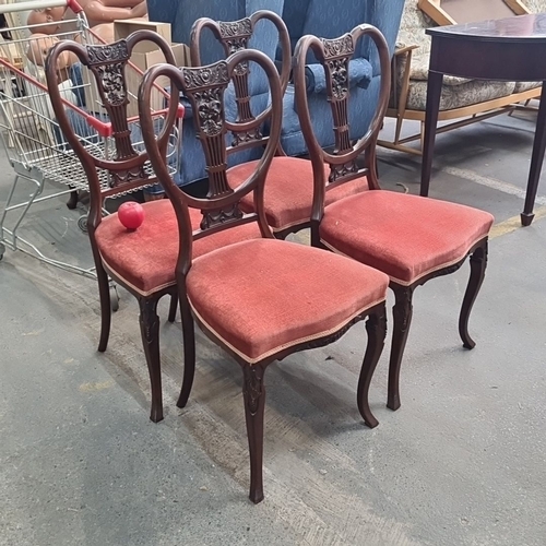 858 - Set of four Edwardian mahogany dining chairs featuring intricately carved backs and upholstered seat... 