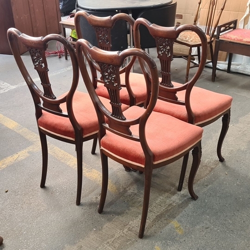 858 - Set of four Edwardian mahogany dining chairs featuring intricately carved backs and upholstered seat... 