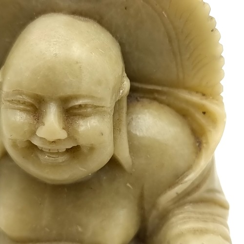 973 - A carved soap stone Happy Buddha figure. Dimensions - H - 9 cms, W - 6.5 cms. Weight - 250 grams.