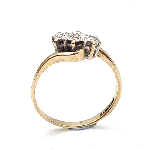 7 - A three stone illusion set diamond ring with twist mount hallmarked nine carat gold (375). Ring size... 