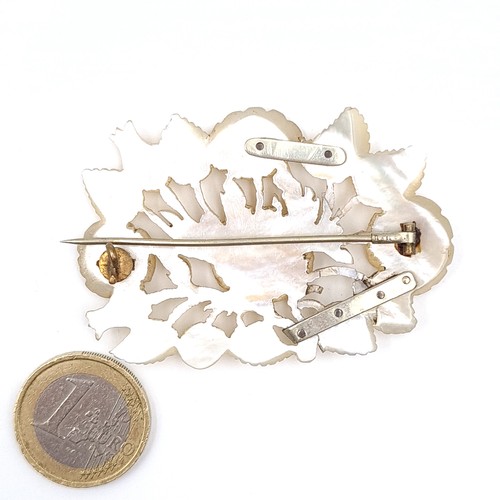 13 - An antique mother of pearl floral designed brooch. Dimensions - 6 x 4 cms. Weight - 17 grams. Pin in... 