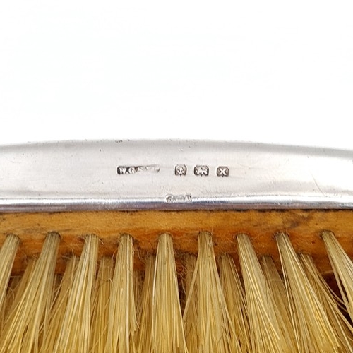 14 - A pair of sterling silver backed clothes brushes hallmarked Birmingham - 1947. Presented in its orig... 