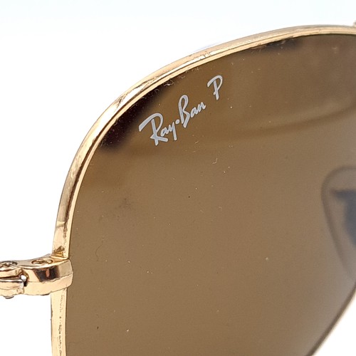 29 - A pair of original gold metal framed marked Ray-Ban aviator style sunglasses. Comes in a pouch.