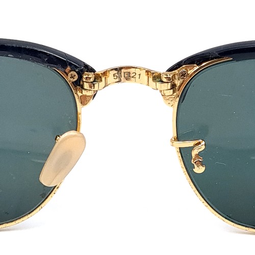 31 - A pair of rare folding sunglasses by Ray-Ban with gold metal detailing with original case.