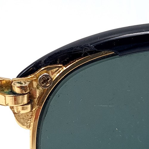 31 - A pair of rare folding sunglasses by Ray-Ban with gold metal detailing with original case.