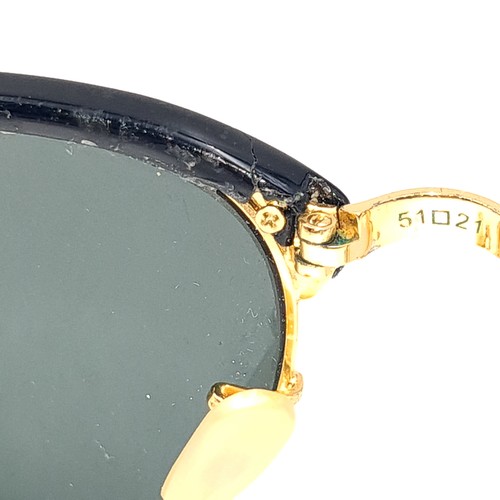 31 - A pair of rare folding sunglasses by Ray-Ban with gold metal detailing with original case.