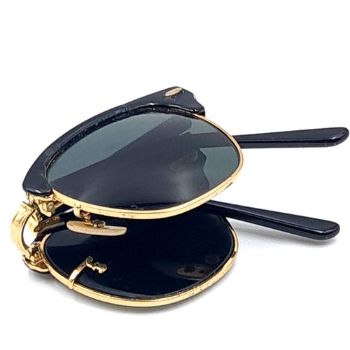 31 - A pair of rare folding sunglasses by Ray-Ban with gold metal detailing with original case.