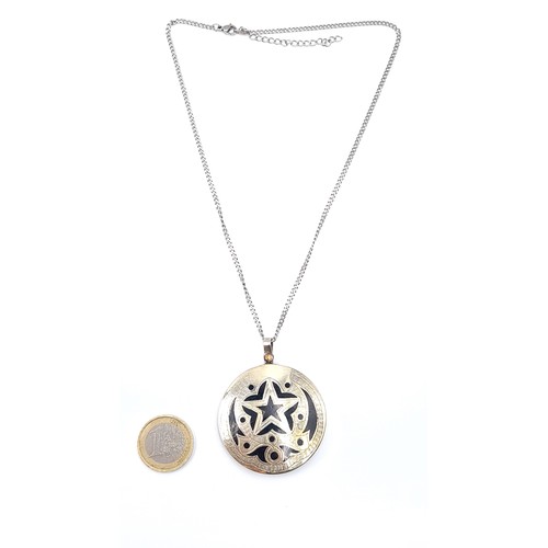 32 - An Asian pendant set with star motif with gold & sterling silver mounts set in onyx stone with silve... 