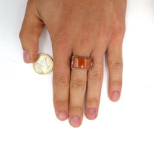 47 - Star Lot : A very unusual carnelian stone ring of 14 carats. Together with a diamond surround of 0.2... 