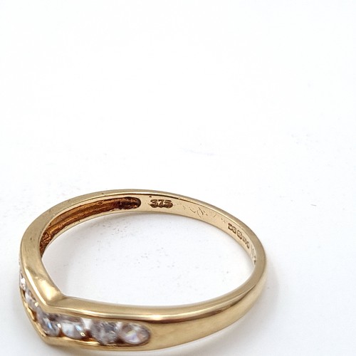 934 - A nine carat gold gem set wishbone ring. Size - N. Weight - 1.36 grams. Boxed.