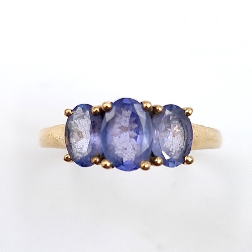 937 - Star Lot : A nine carat gold (375) three stone Tanzanite ring. Ring size - O. Weight - 2.08 grams. B... 