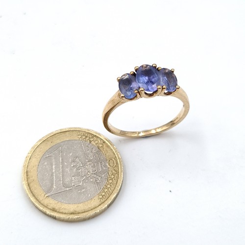 937 - Star Lot : A nine carat gold (375) three stone Tanzanite ring. Ring size - O. Weight - 2.08 grams. B... 