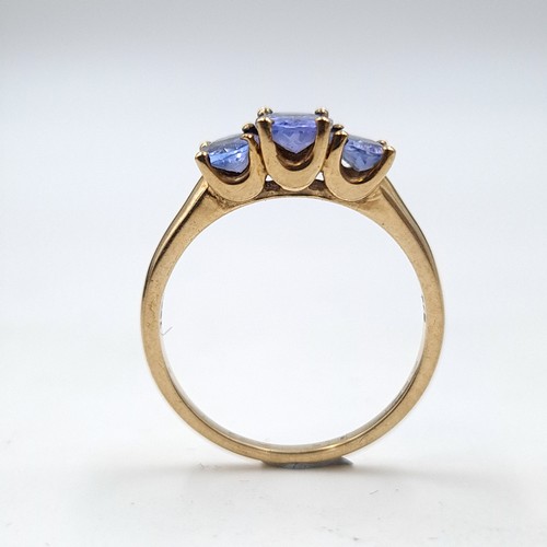 937 - Star Lot : A nine carat gold (375) three stone Tanzanite ring. Ring size - O. Weight - 2.08 grams. B... 