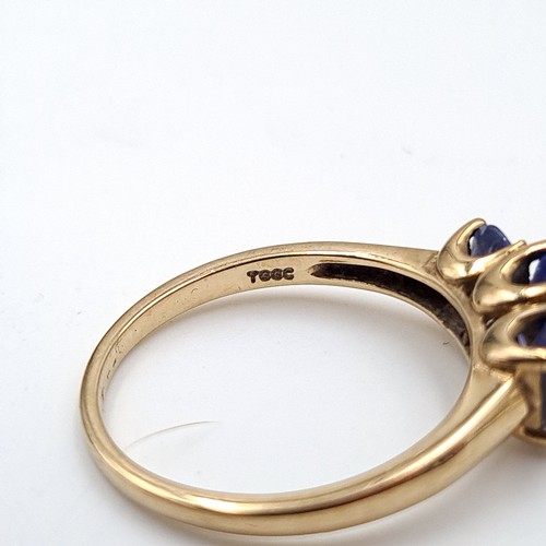 937 - Star Lot : A nine carat gold (375) three stone Tanzanite ring. Ring size - O. Weight - 2.08 grams. B... 