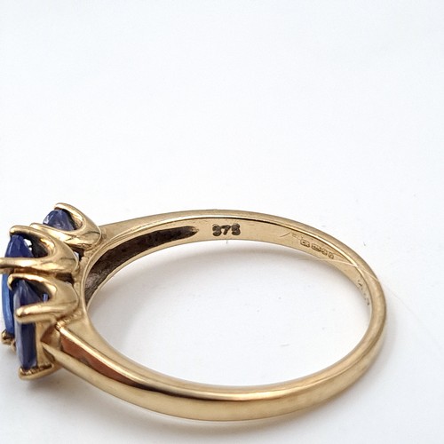 937 - Star Lot : A nine carat gold (375) three stone Tanzanite ring. Ring size - O. Weight - 2.08 grams. B... 