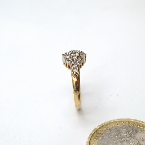 938 - A lovely vintage diamond cluster ring. Est weight of diamonds - 0.4 carats set in nine carat gold. R... 