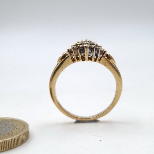 938 - A lovely vintage diamond cluster ring. Est weight of diamonds - 0.4 carats set in nine carat gold. R... 