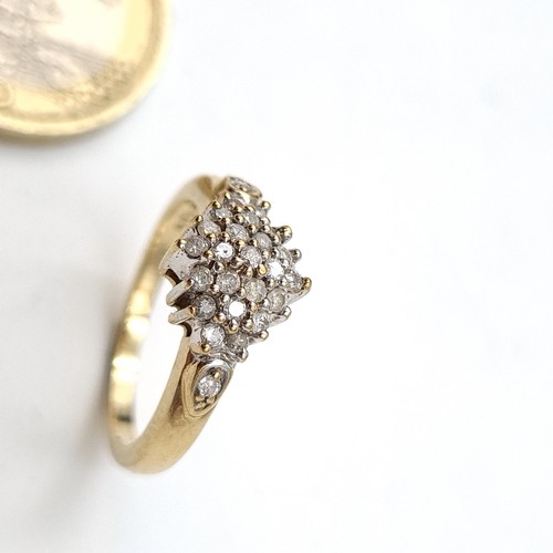 938 - A lovely vintage diamond cluster ring. Est weight of diamonds - 0.4 carats set in nine carat gold. R... 