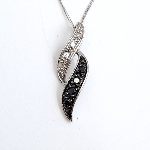 948 - A fine 9ct whit gold chain with a 9ct white gold pendent with black and white diamonds.  - 46 cms. B... 