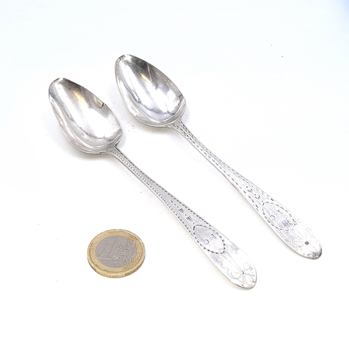 15 - Two bright cut Irish silver teaspoons (Marks indistinct) Length - 14 cms. Weight - 30.23 grams.