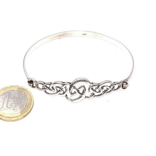 28 - A silver bracelet set with Celtic scroll design. Weight - 11.71 grams. Boxed.