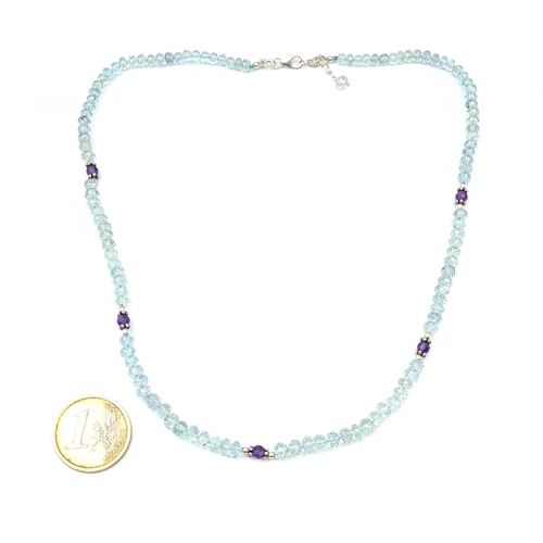 45 - A fabulous aquamarine necklace with amethyst set spaces with silver clasps. Length - 44 cms. Weight ... 