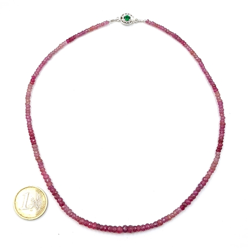 46 - A natural ruby necklace with an emerald clasp set in sterling silver. Length - 42 cms. Weight - 17.7... 