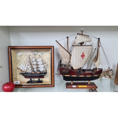 669 - Two maritime collectibles: a framed model ship on a background map and a hand-crafted model of the S... 