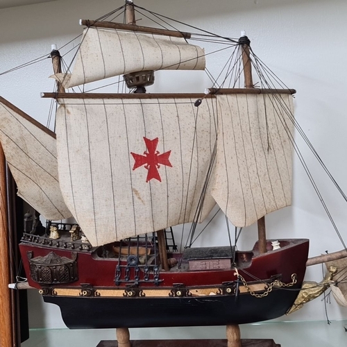 669 - Two maritime collectibles: a framed model ship on a background map and a hand-crafted model of the S... 