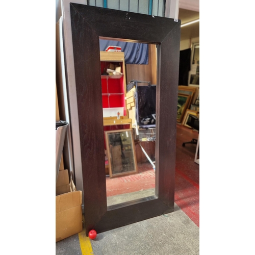 114 - A very large dark brown wooden framed 'Mongstad' mirror. Features wall hanging brackets to verso.
MM... 